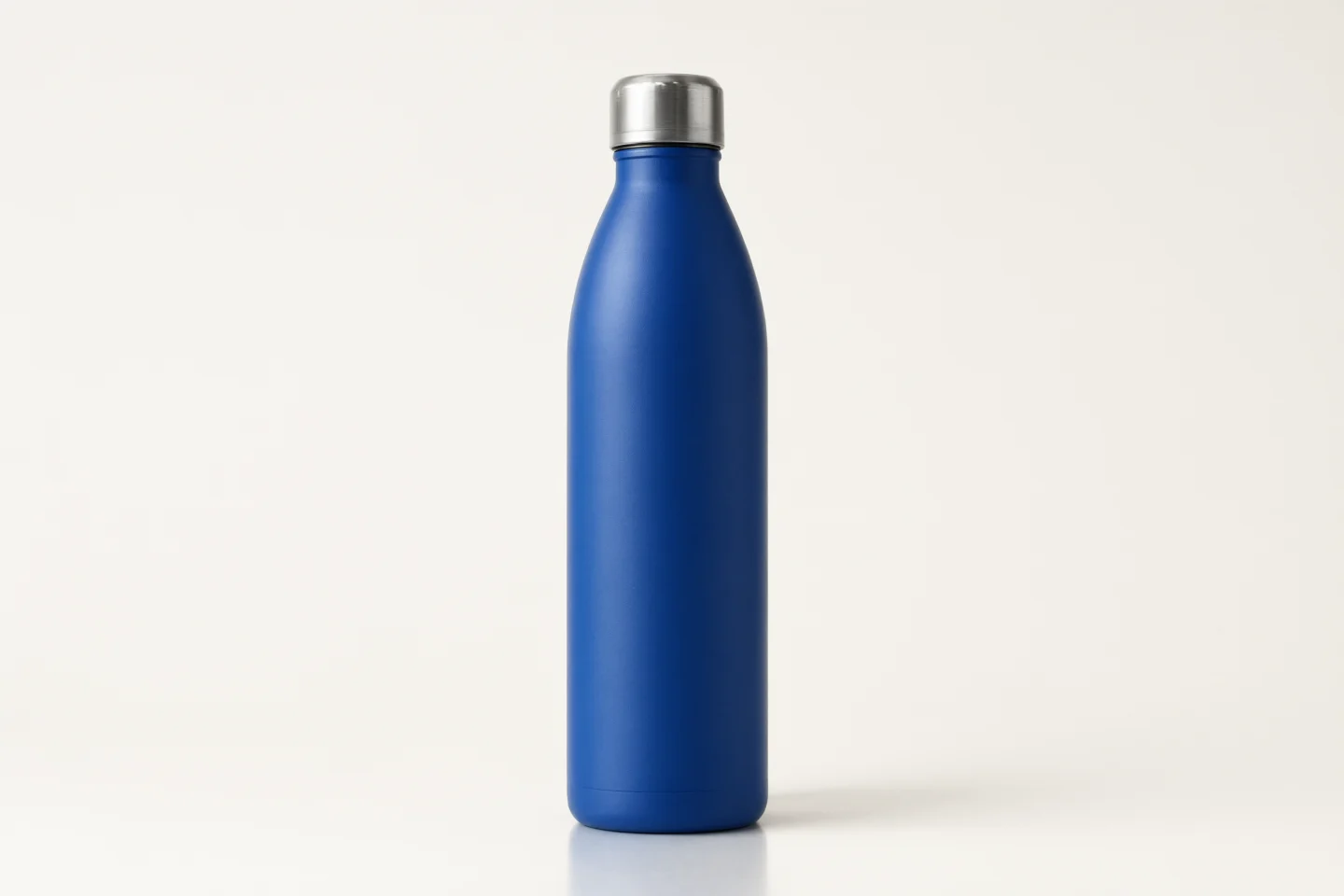 Cobalt blue insulated water bottle centered on an off white background